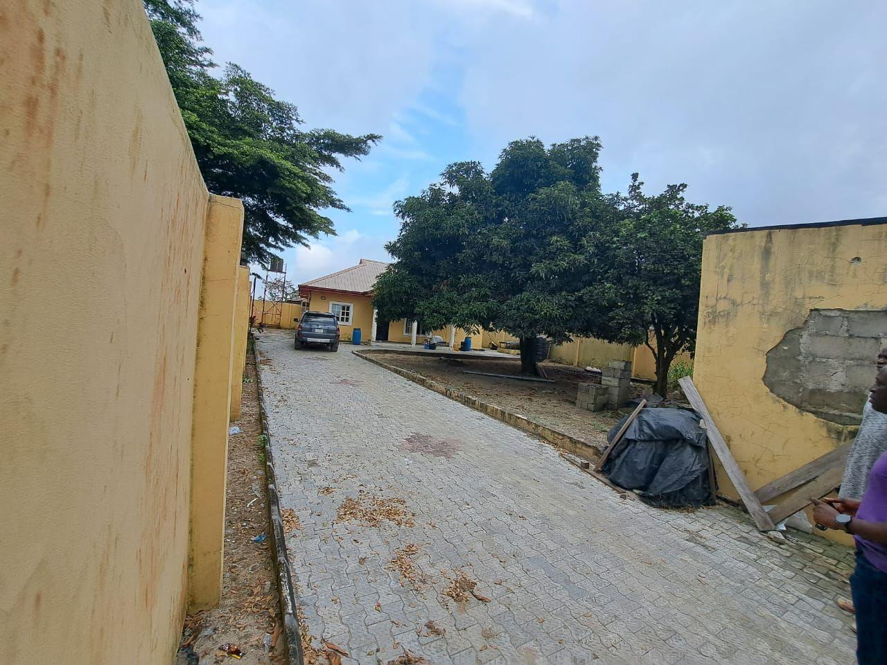 A full Plot Of Land With 3 Bedroom Bungalow, and 5 shops in front on the same land available FOR SALE